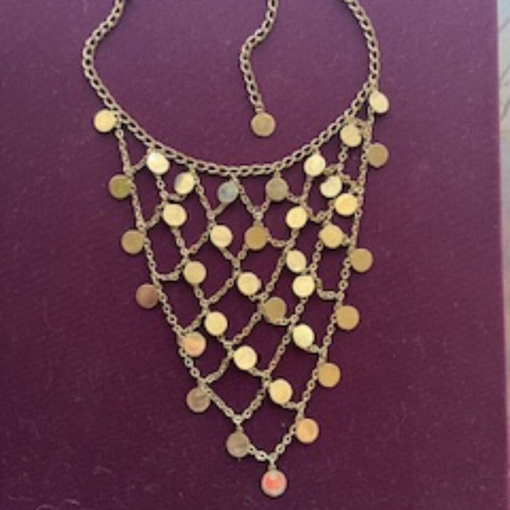 Vintage gold-tone metal disc bib necklace with a net-like chain design.